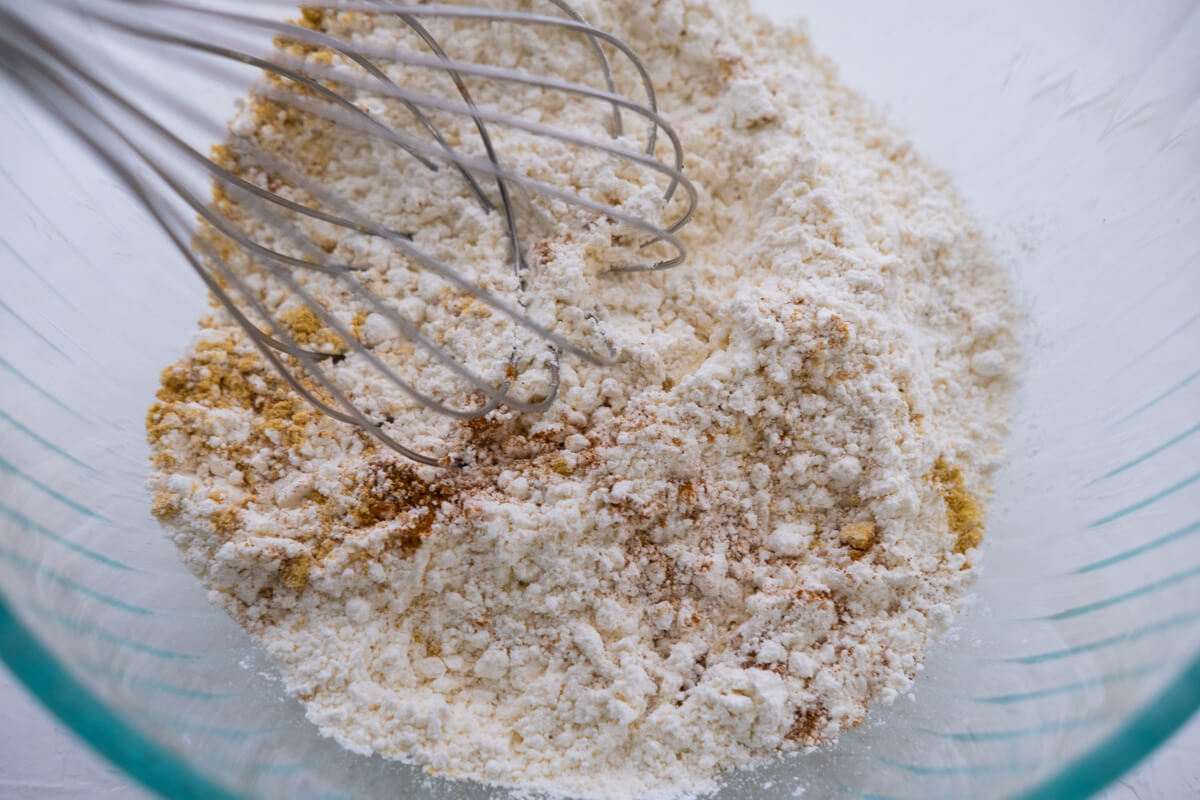 In a large bowl, whisk together the flour, baking soda, and spices. Set aside.