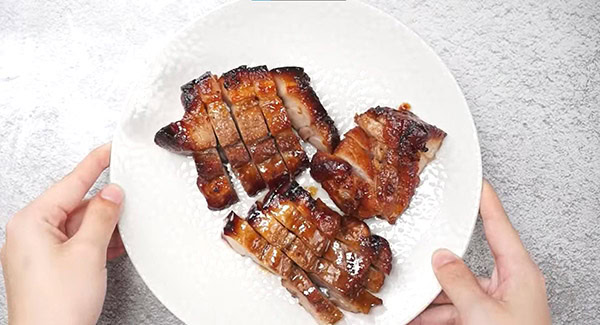 Sliced Chinese BBQ pork served on plate.