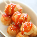 Fried cuttlefish balls threaded on a bamboo skewer.