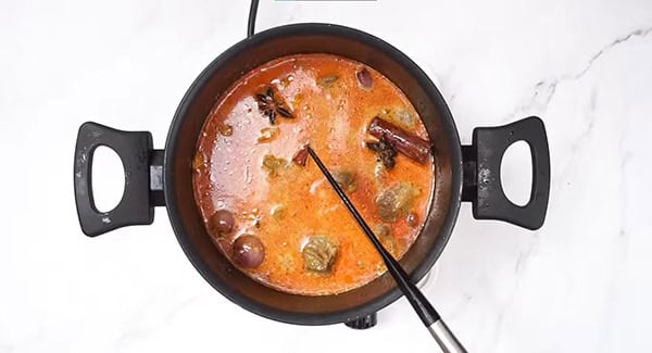 Add coconut milk, fish sauce and water into the pot.