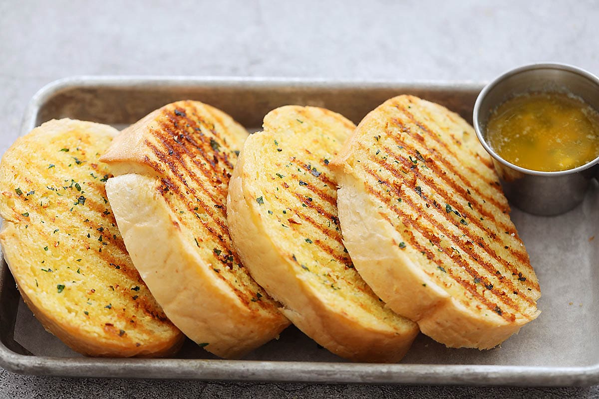 Golden crispy garlic bread made on the stove top. 