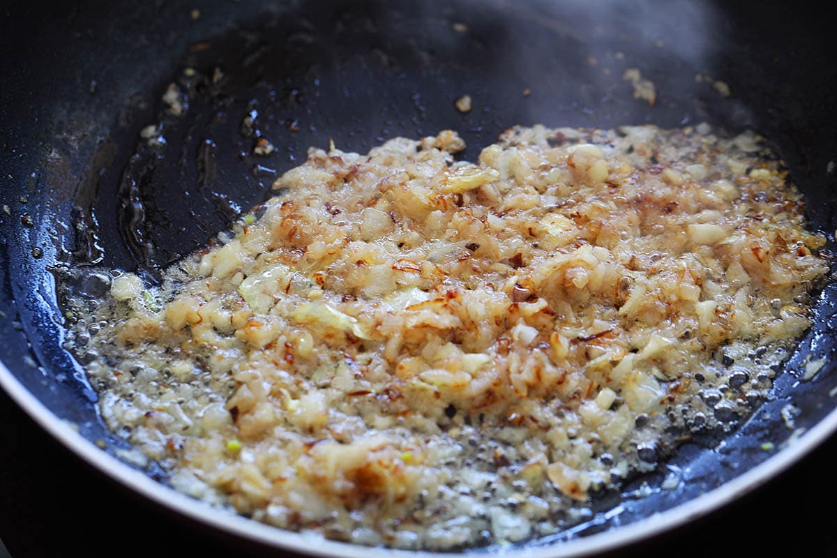 Cooking ginger, garlic and onion in a skillet.