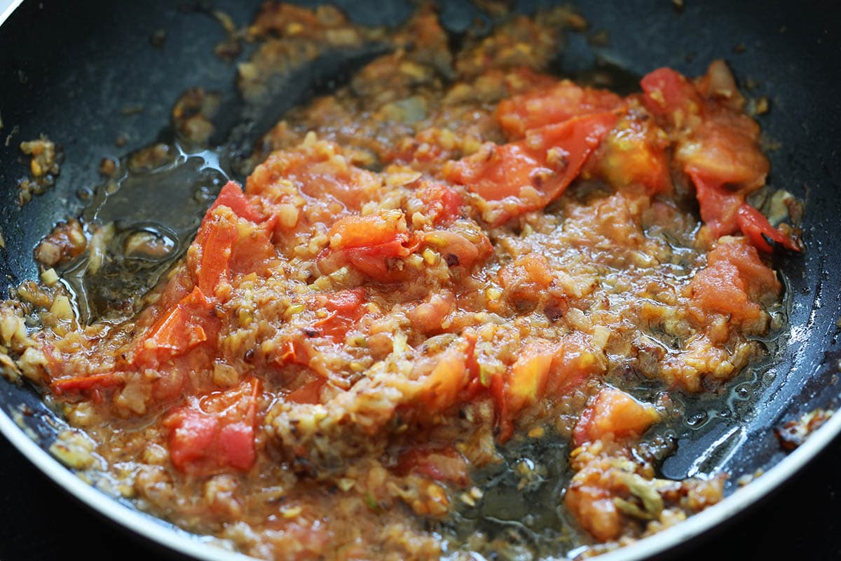 Tomatoes and spices in a skillet.