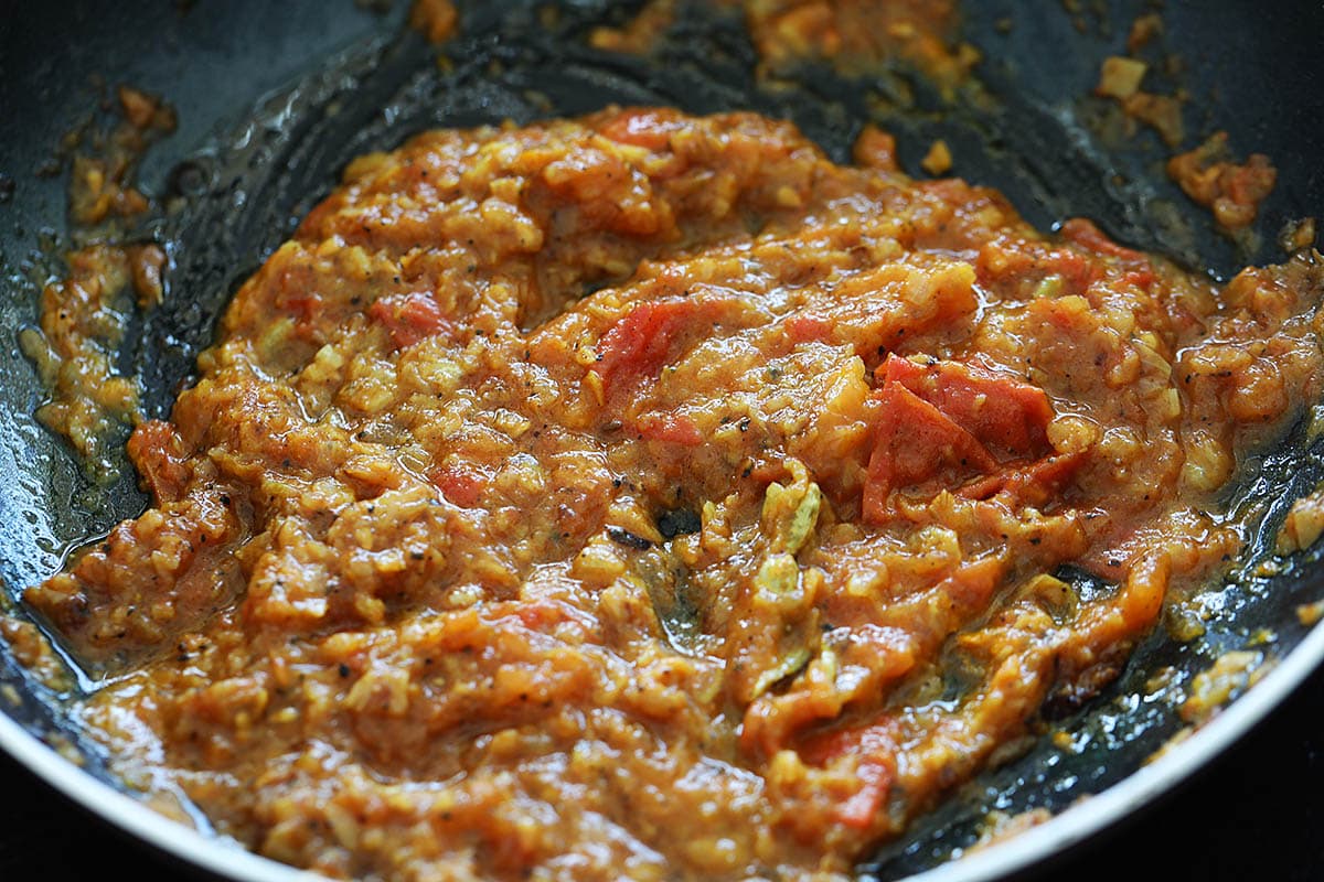 Masala spice paste for cardamom chicken in skillet.