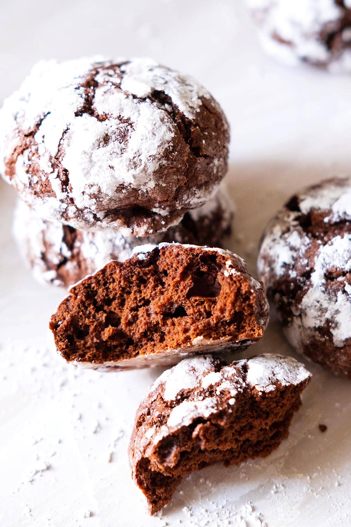 Fudgy crinkle cookie cookies broken into halves.