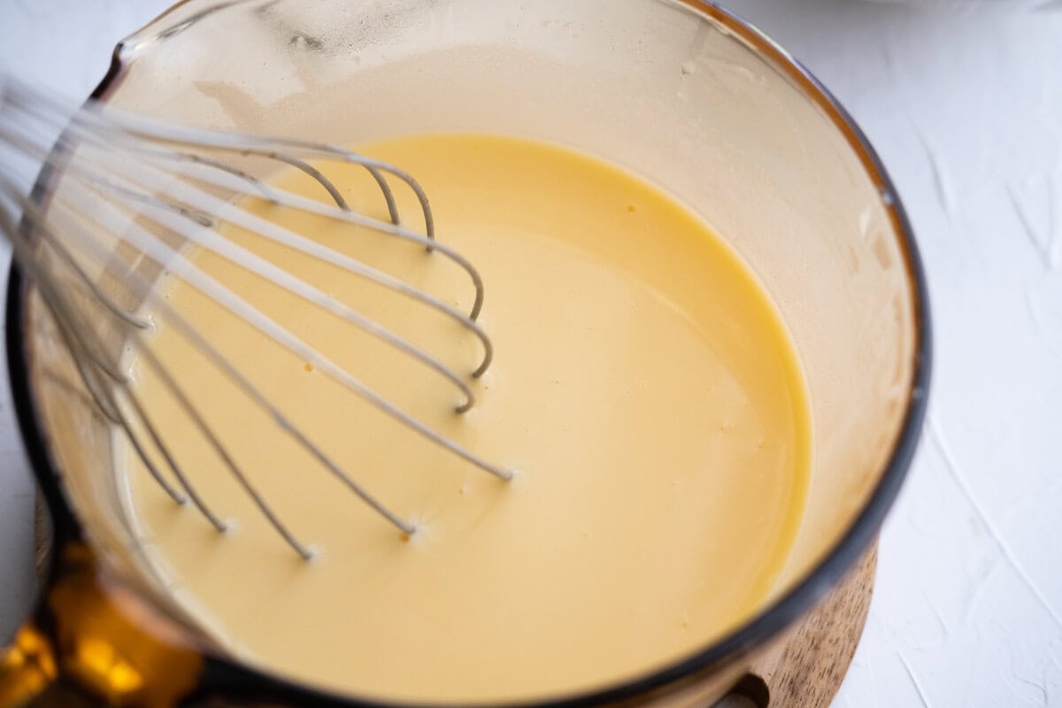 Cook butter, sugar, evaporated milk and vanilla extract in a saucepan. 