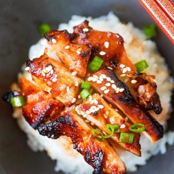 Stir fry Korean spicy chicken with a pair of chopsticks.