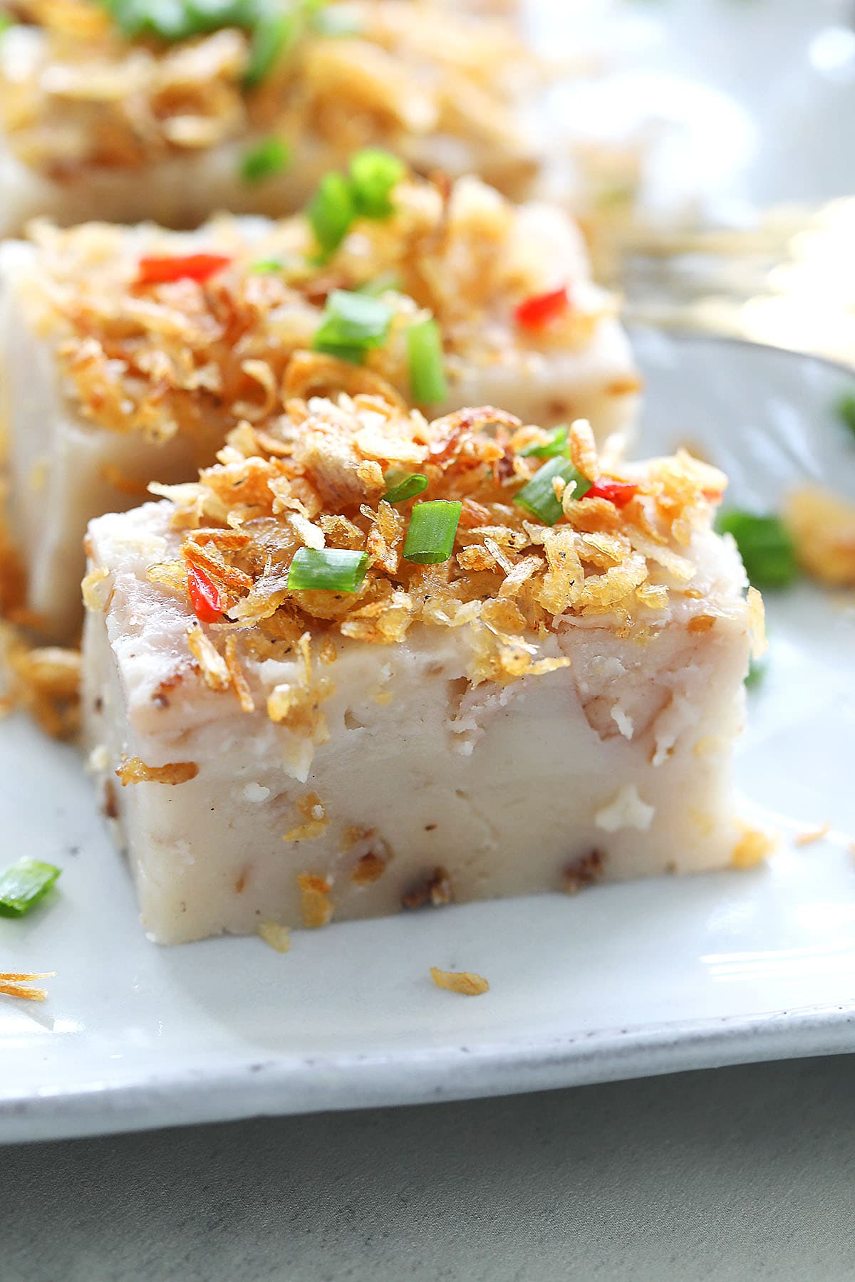 Penang Or Kuih topped with dried shrimp, fried shallot crisps and scallions.