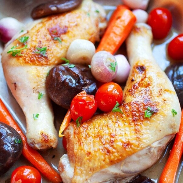 Simple braised chicken recipe with chicken quarters and mushrooms, tomatoes and carrots.