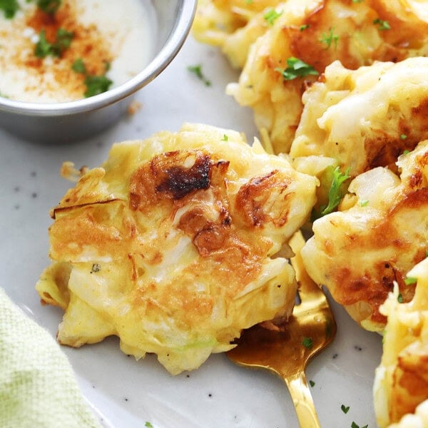 Crispy cabbage fritters recipe made with shredded cabbage, eggs, onions and flour.