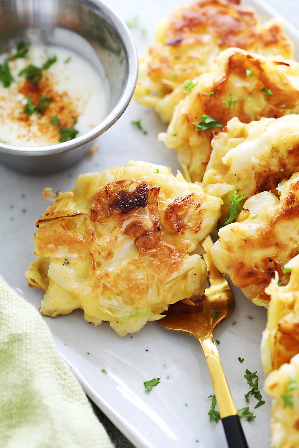 Crispy cabbage fritters recipe made with shredded cabbage, eggs, onions and flour.