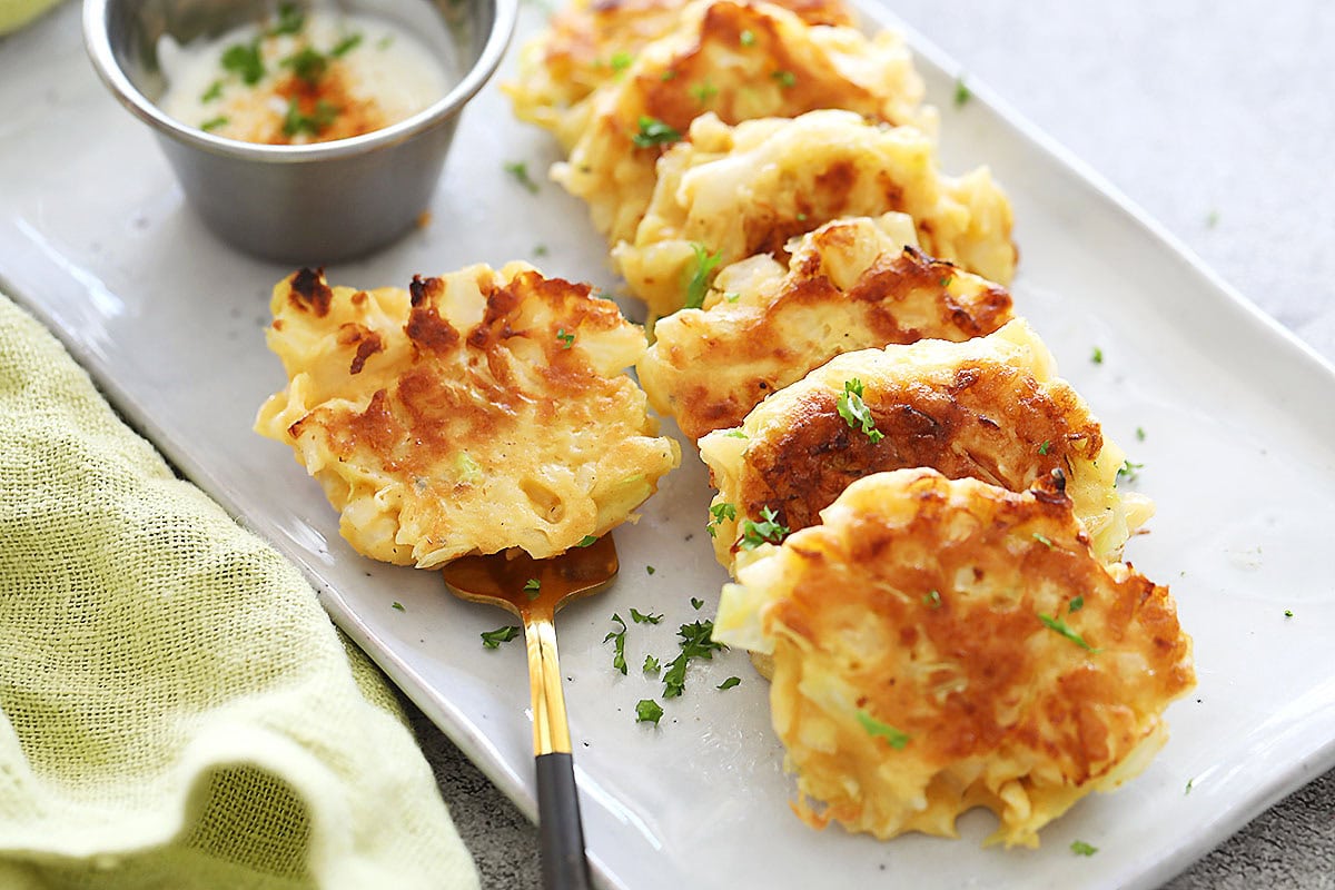 Golden brown pan-fried shredded cabbage fritters.