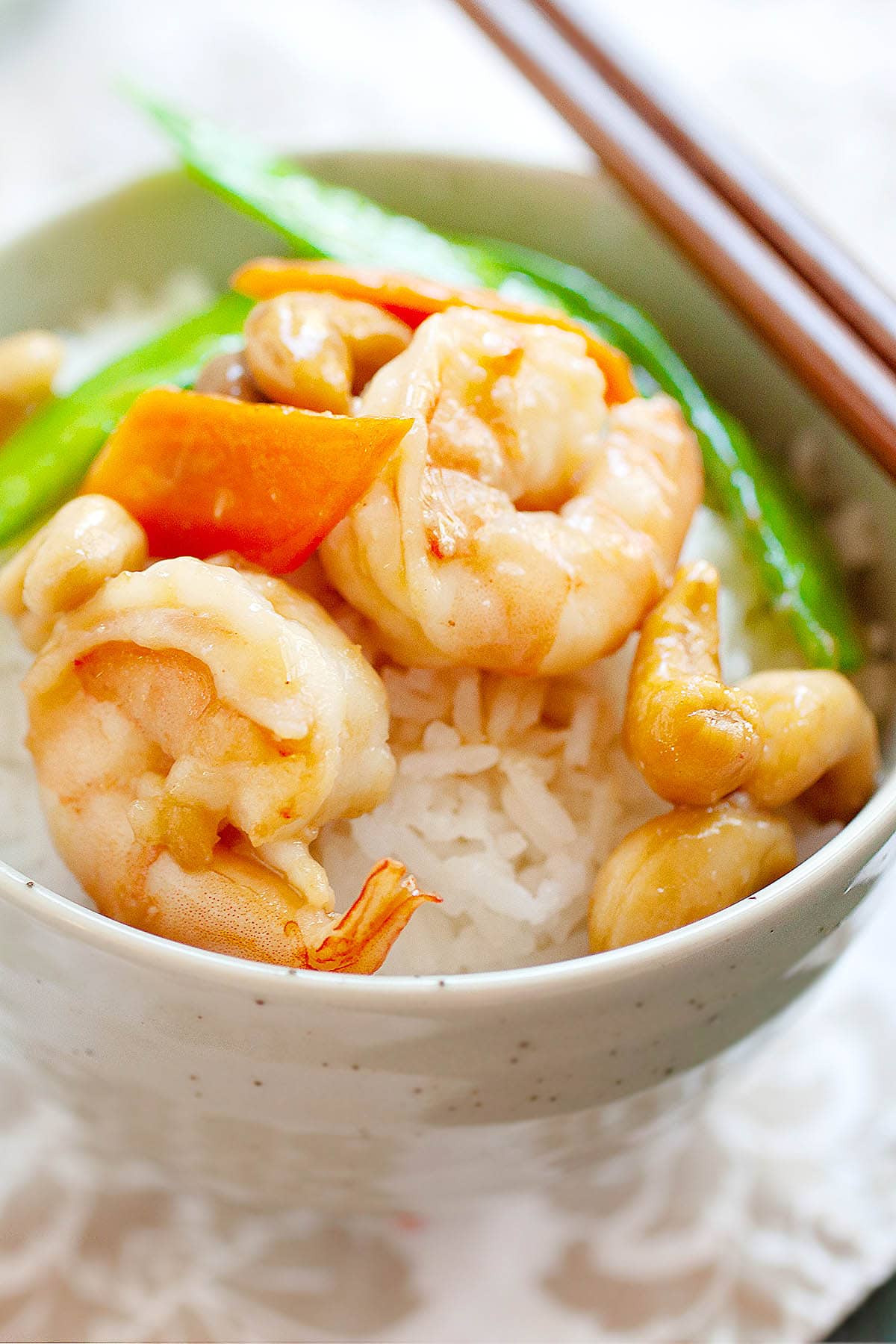 Shrimp with cashew nuts stir fry with carrots and snow peas.