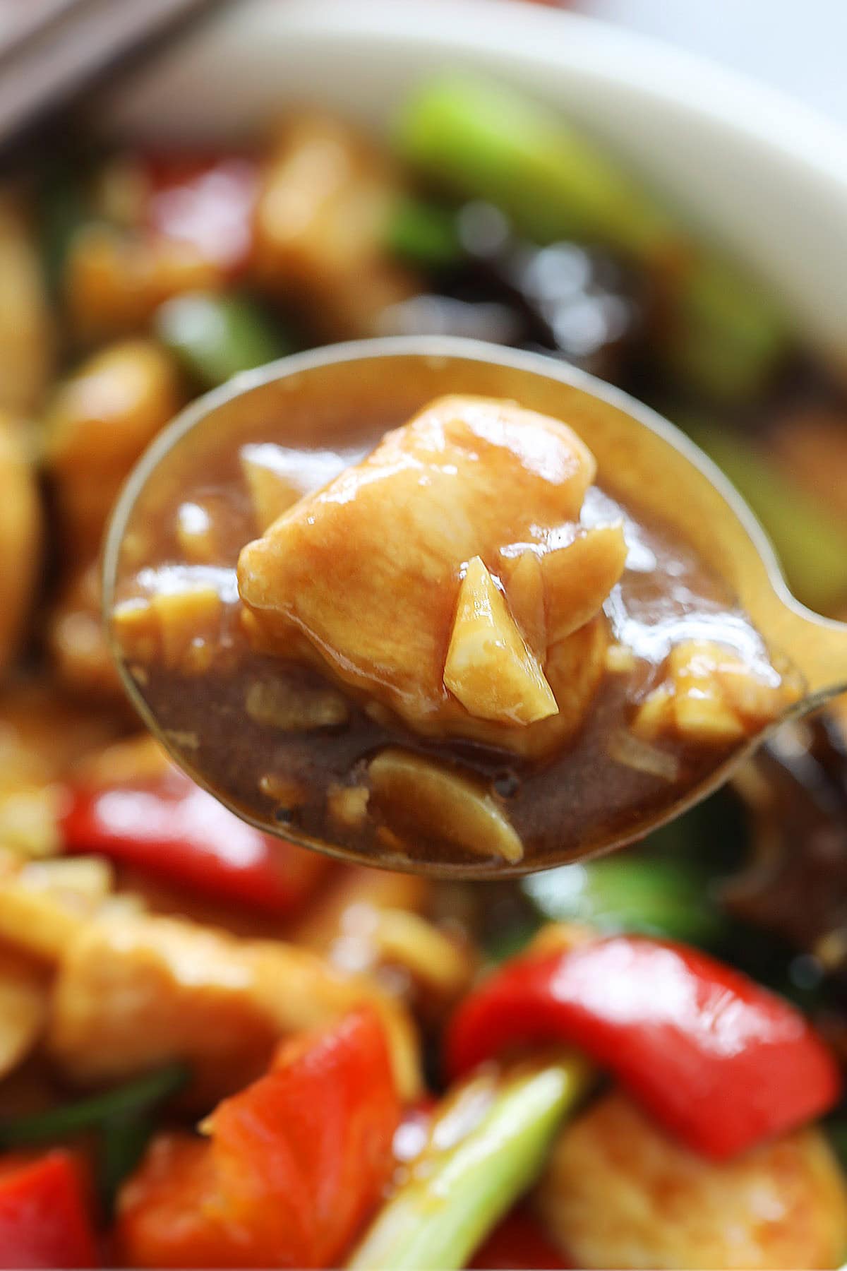 Tender chicken with garlic sauce on a spoon.