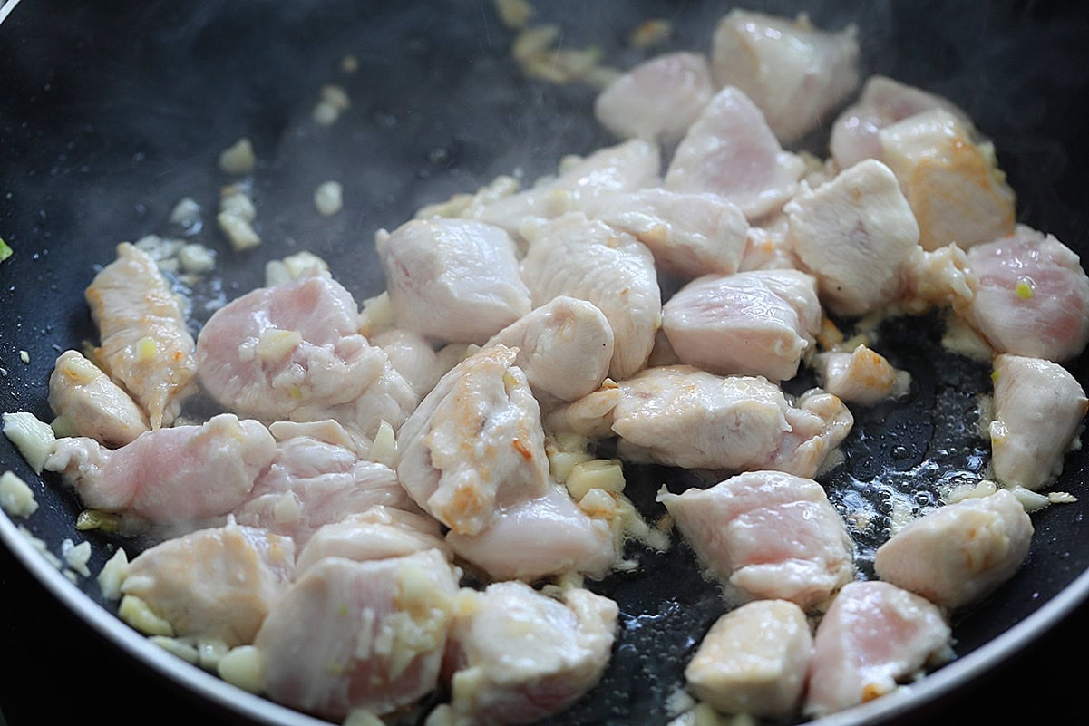 Chicken stir fry in a skillet.