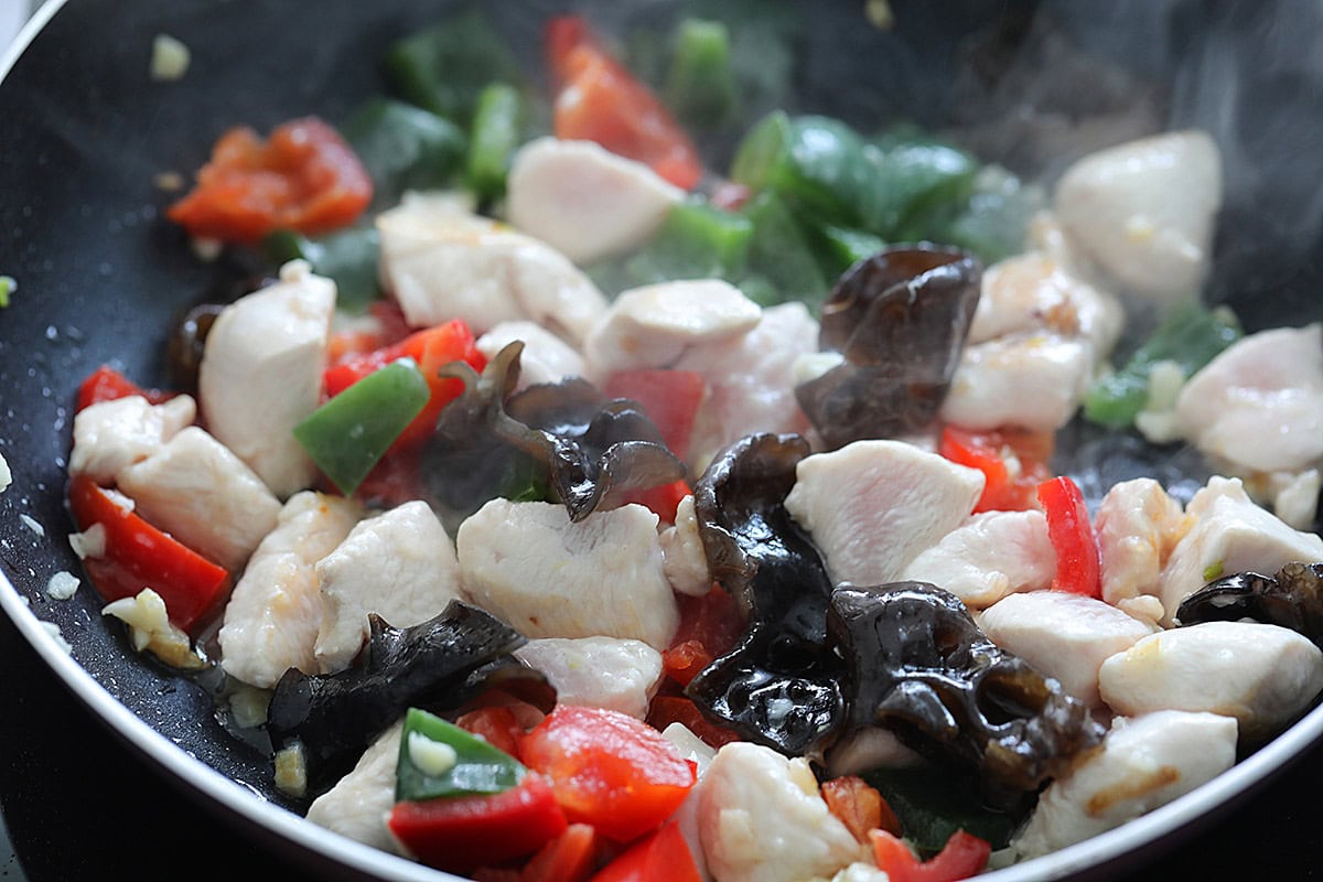 Chinese chicken stir fry with bell peppers and wood ear mushrooms.