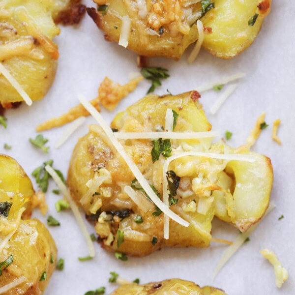 Golden, crispy garlic butter smashed potatoes topped with melted Parmesan and fresh parsley.