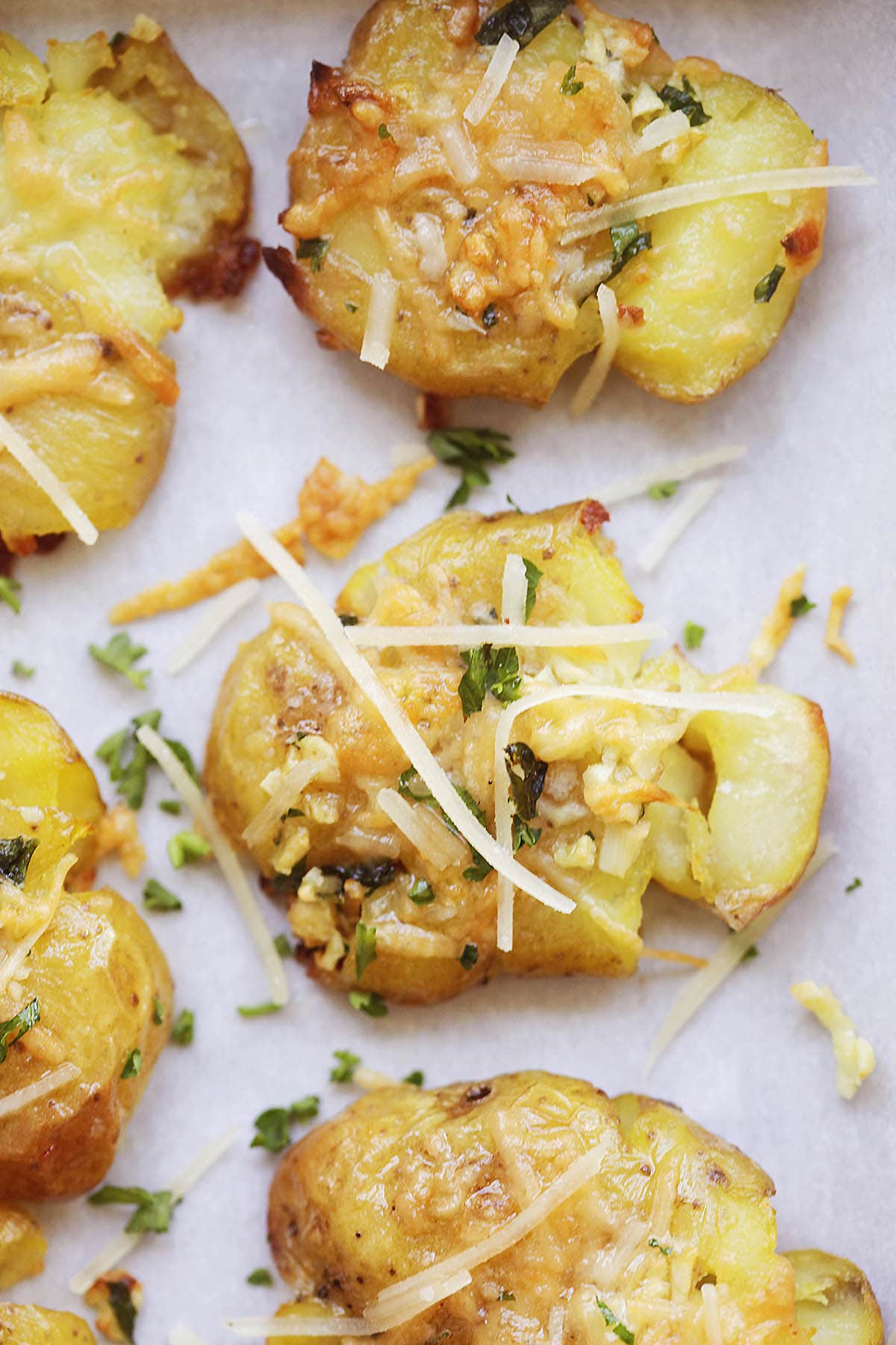 Golden, crispy garlic butter smashed potatoes topped with melted Parmesan and fresh parsley.