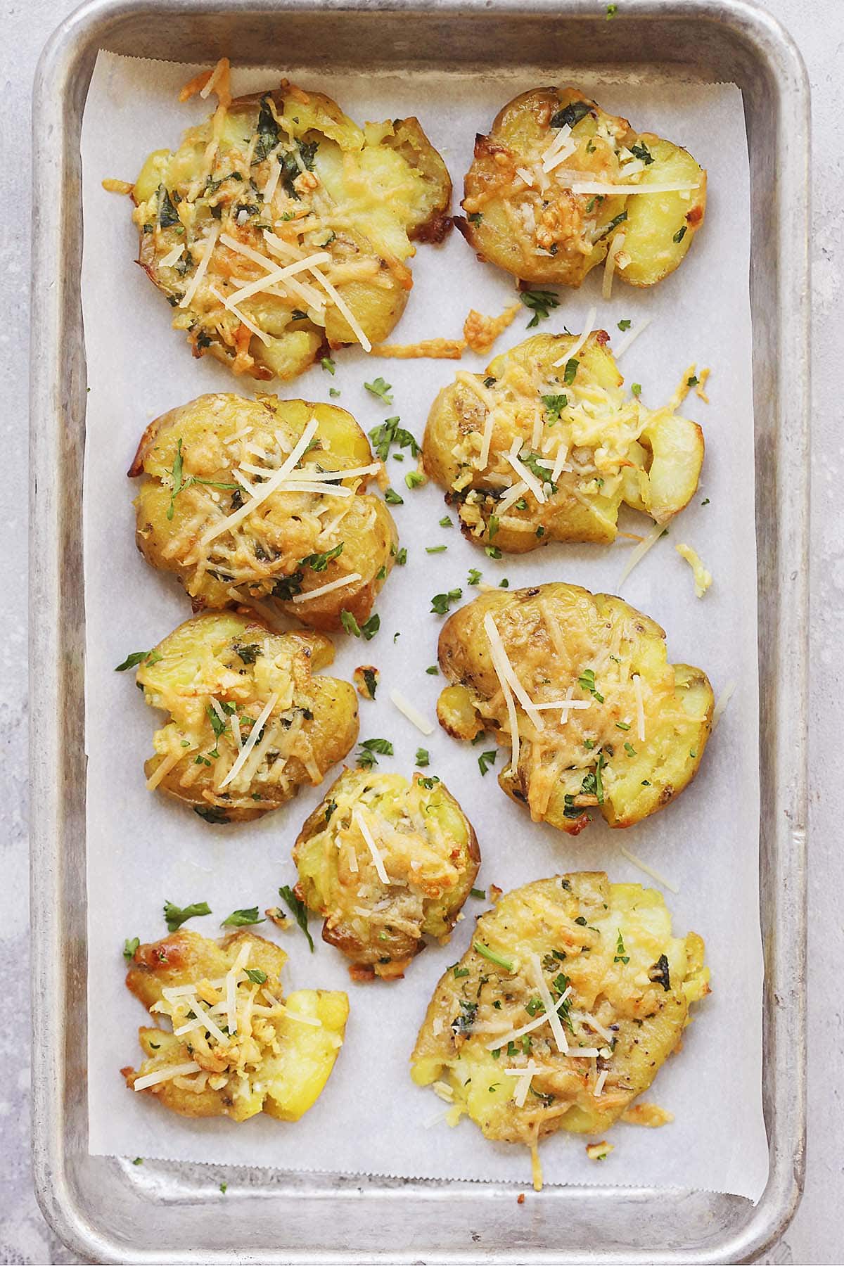 Crispy garlic parmesan smashed potatoes recipe served on a tray.