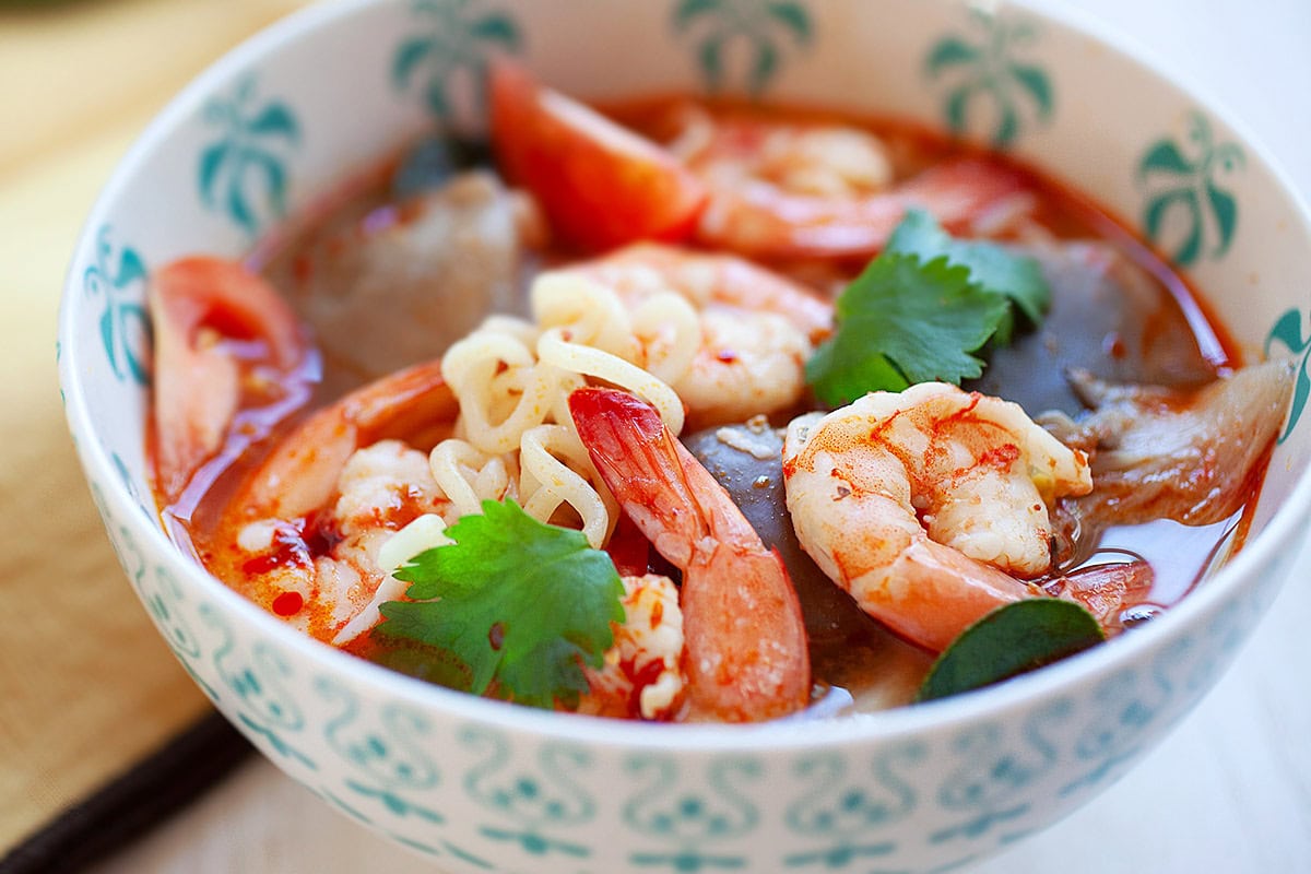 Tom Yum soup noodle garnished with cilantro, ready to serve.