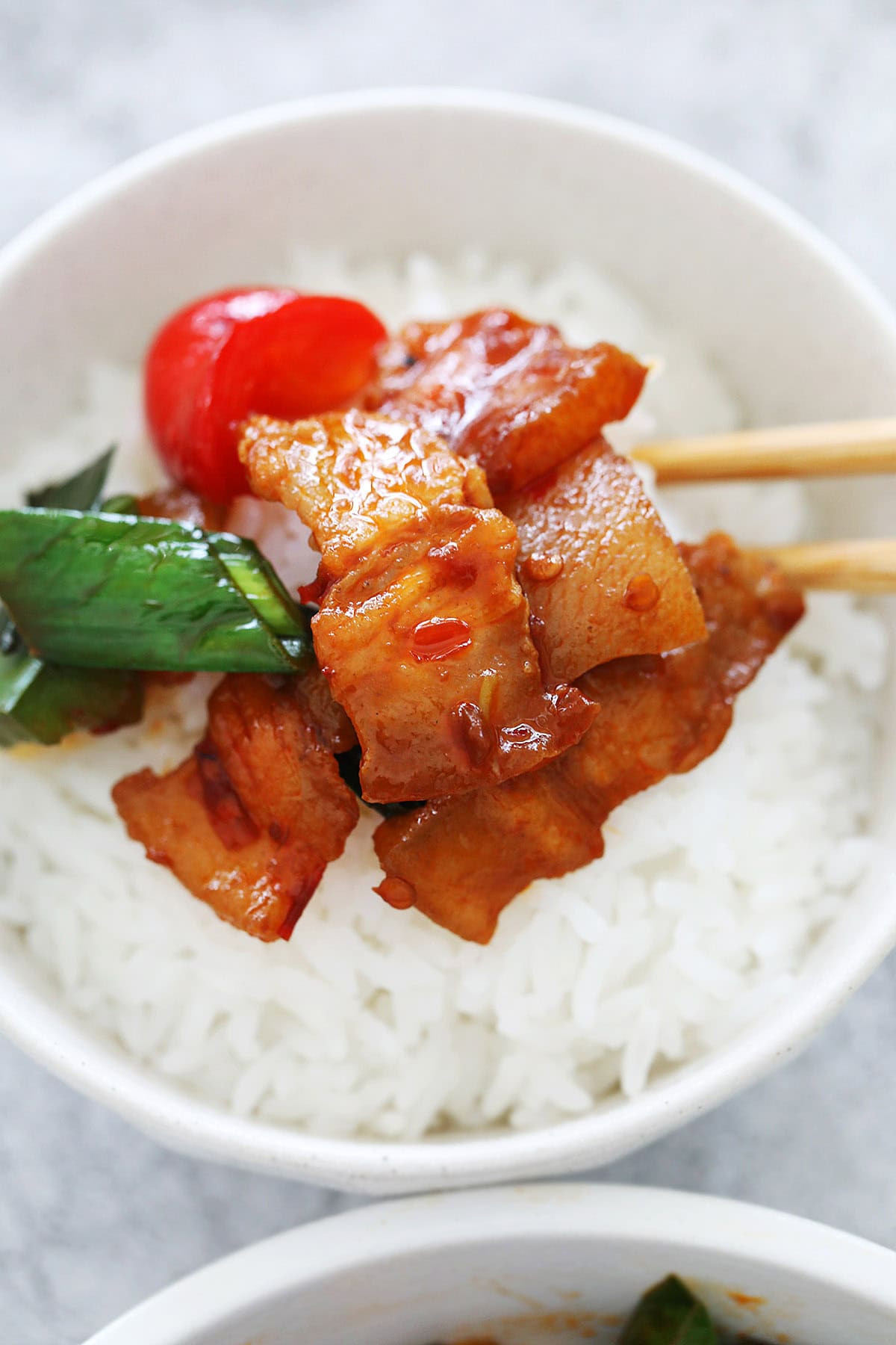 Twice cooked pork belly served over a bowl of steamed rice.