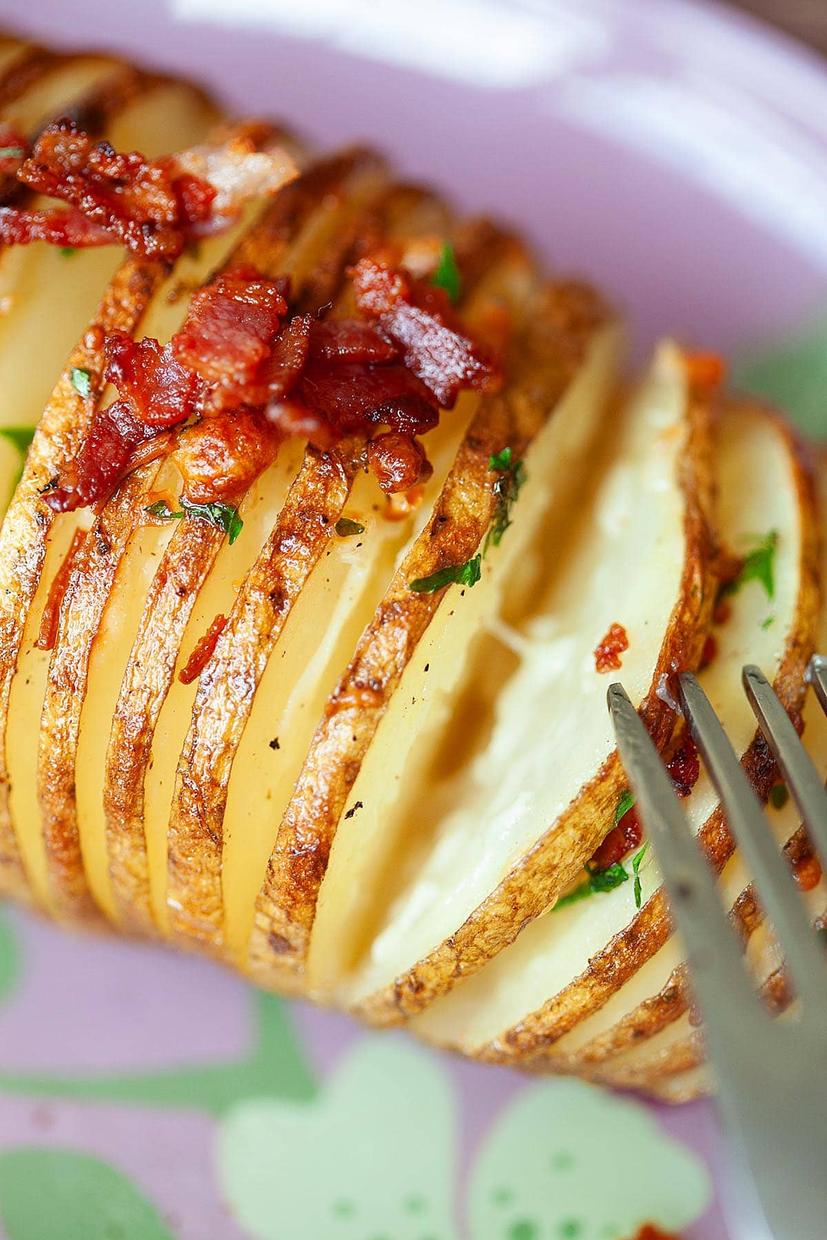 Loaded Hasselback potatoes topped with cheese and crispy bacon.