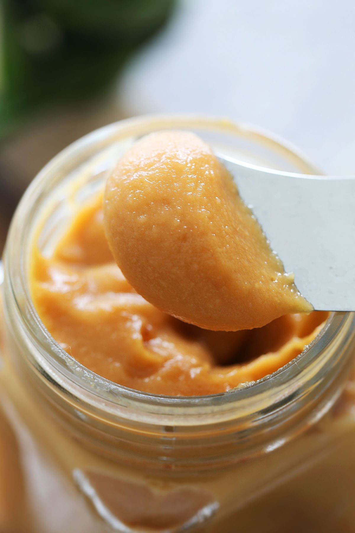 Silky smooth coconut jam kaya spread on a bread knife.