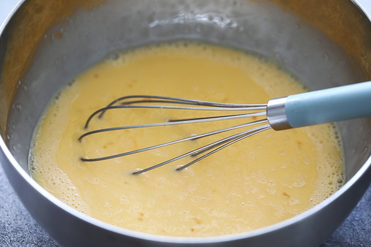 Making coconut jam (kaya jam) recipe with beaten eggs, coconut milk and sugar.