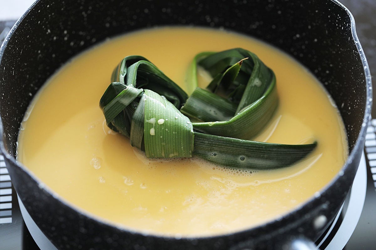 Cooking kaya jam mixture with pandan.