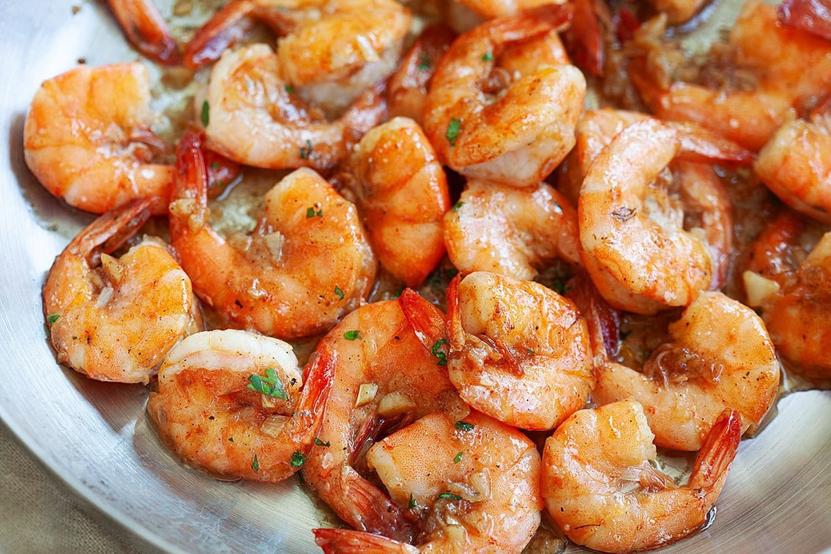 Giovanni shrimp recipe in a skillet with shrimp in savory garlic butter sauce.