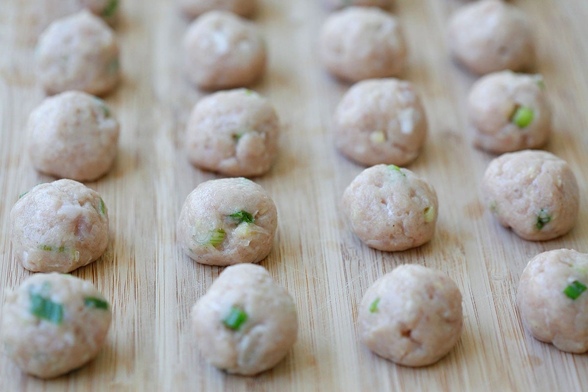 Pork meatballs on a wooden board.