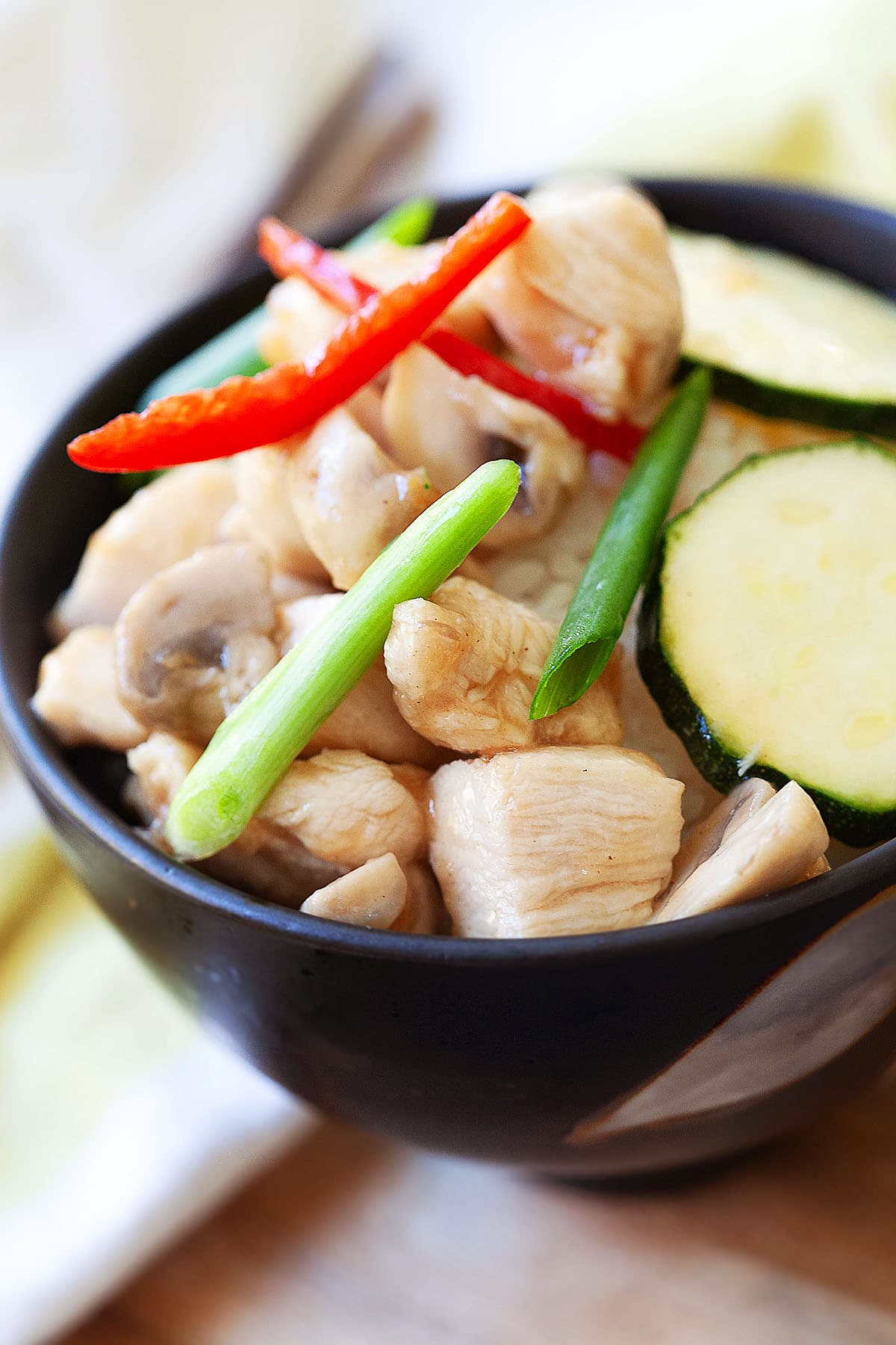 Zucchini stir fry with chicken in a bowl.