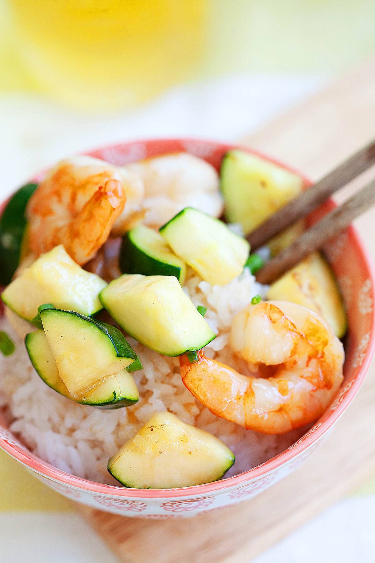 Shrimp and zucchini served in a bowl with steamed rice.