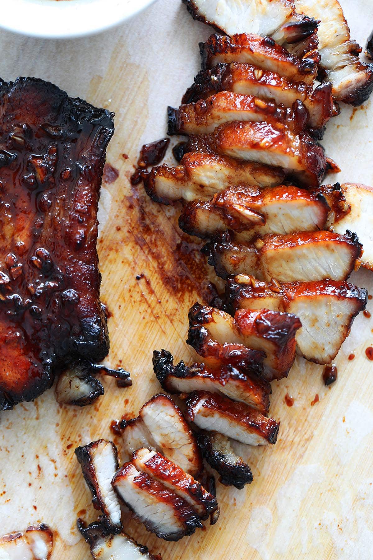 Sliced air fryer char siu on a chopping board.