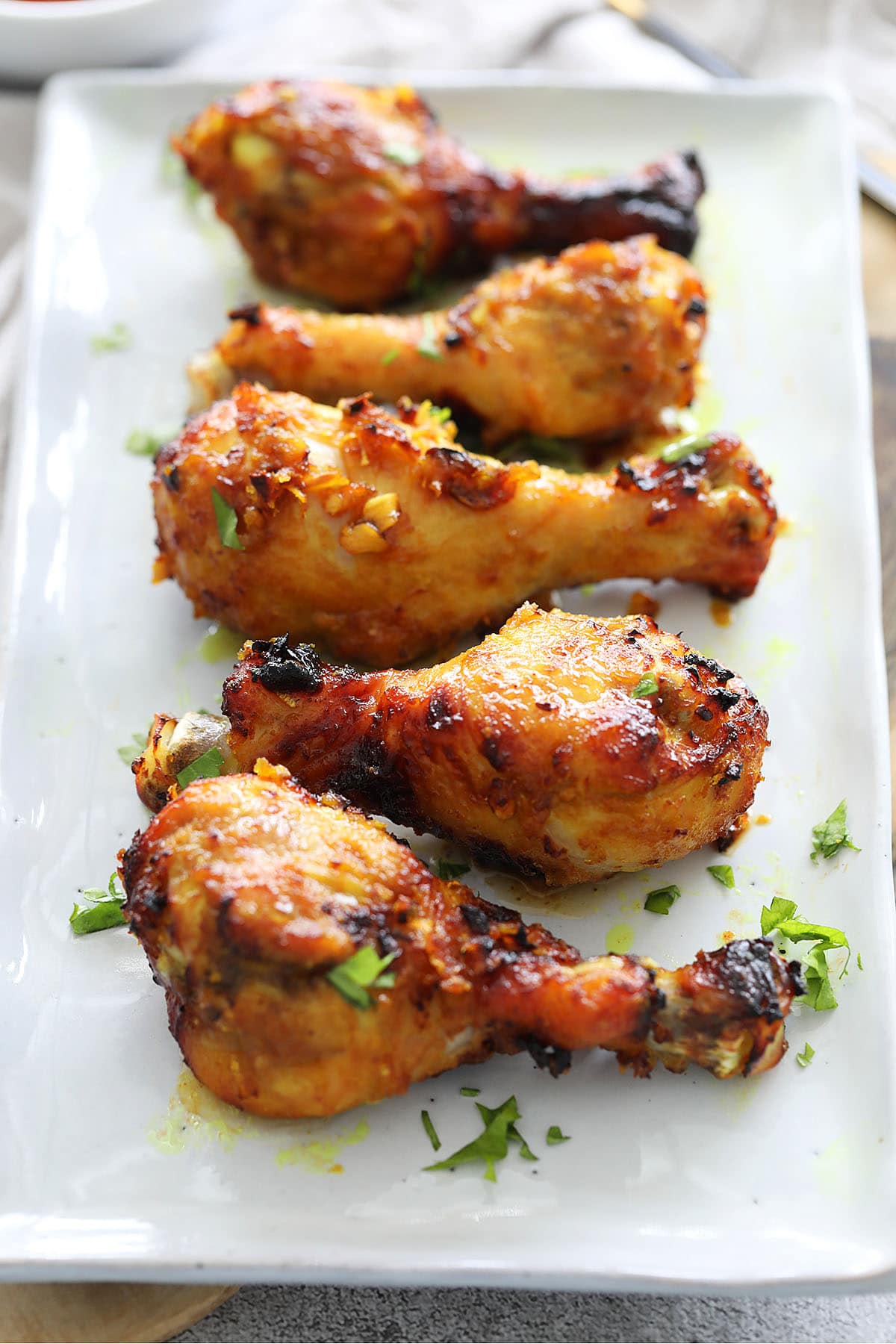 Juicy air fryer chicken legs on a plate, ready to serve.