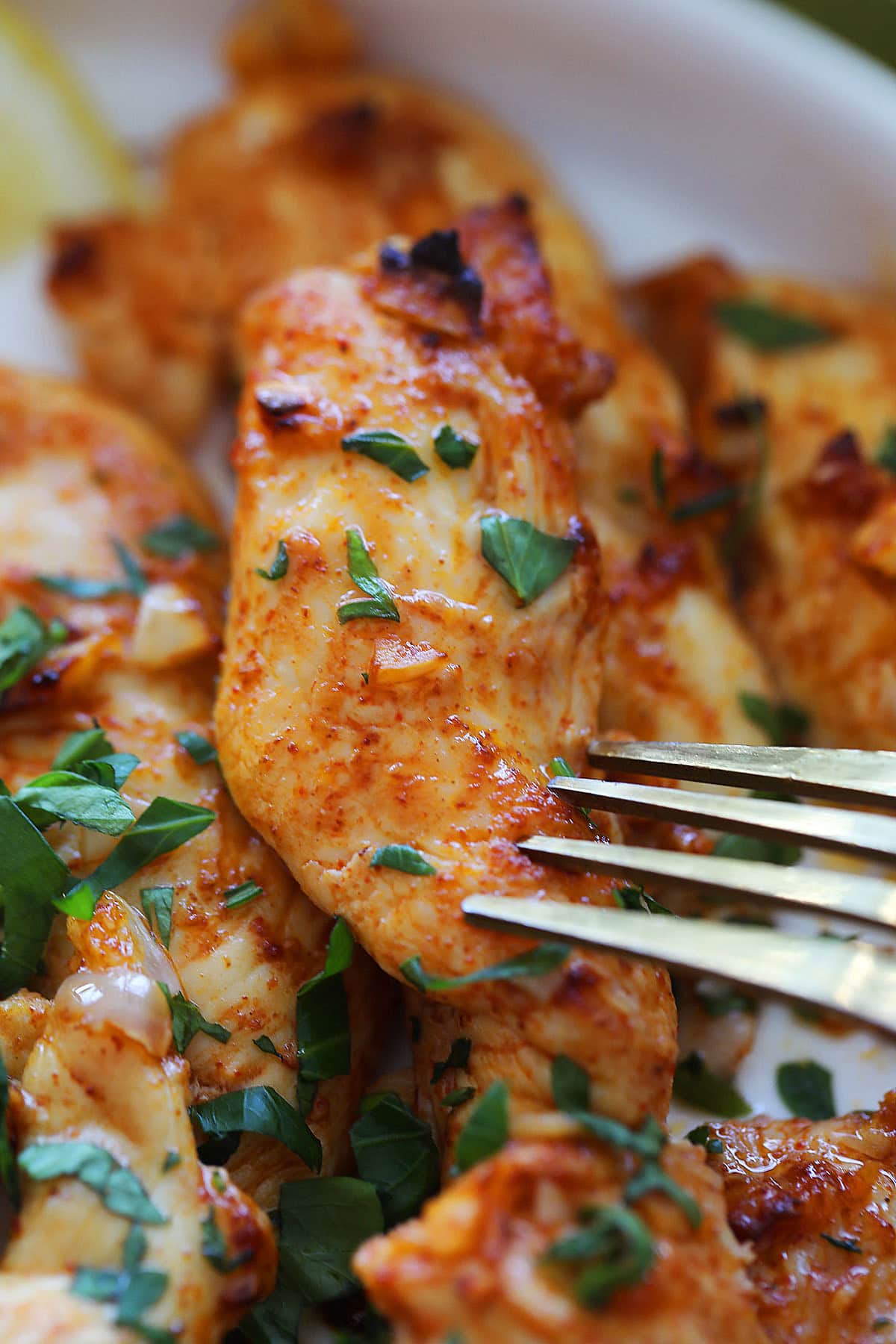 Golden air fryer chicken tender, garnished with fresh parsley.