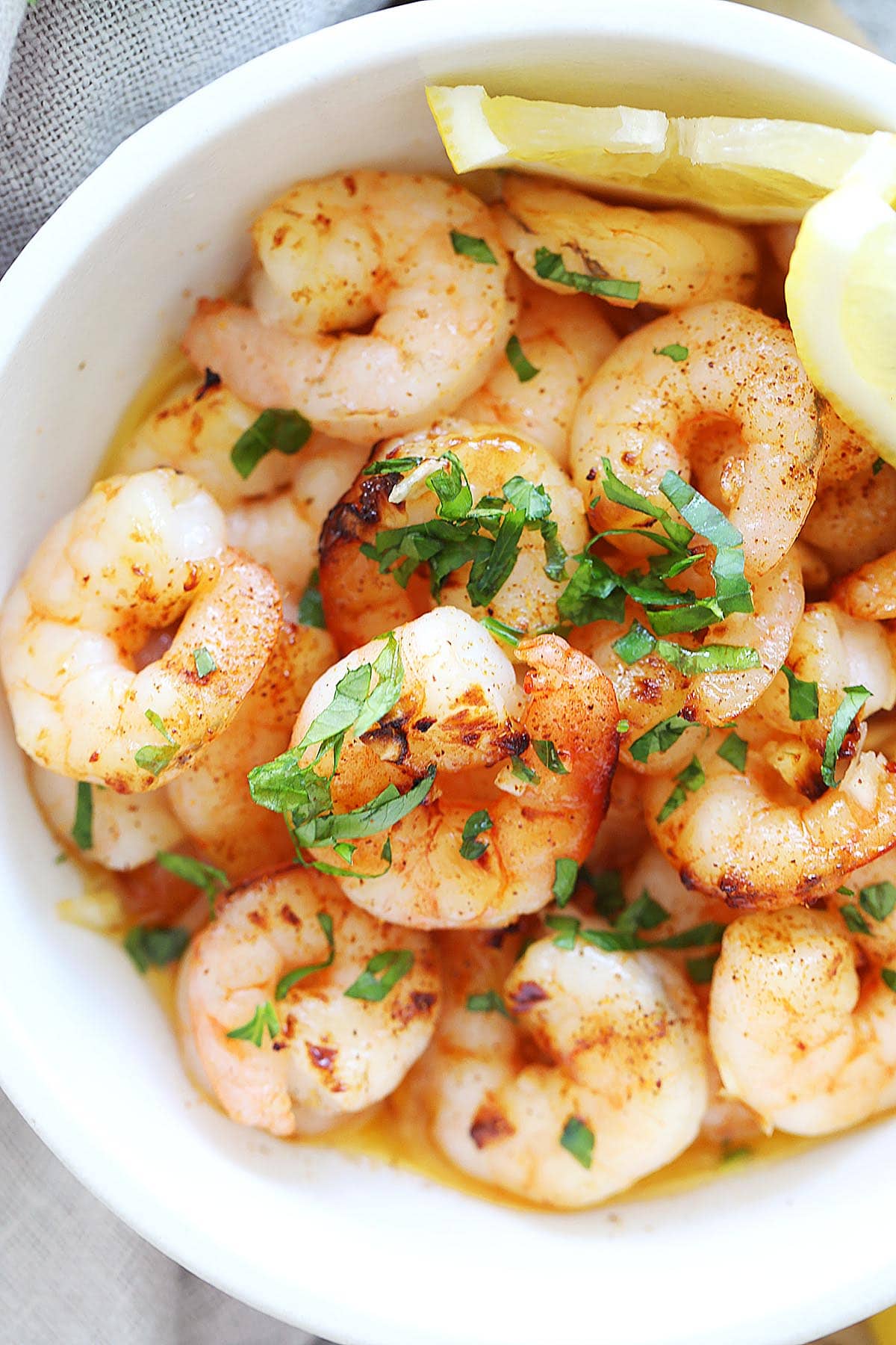 Air fryer honey garlic shrimp, served with lemon wedges and ready for dinner.