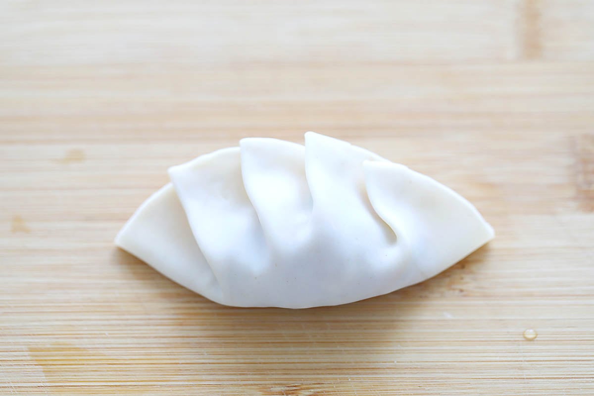 Pleated gyoza wrapper filled with seasoned pork.