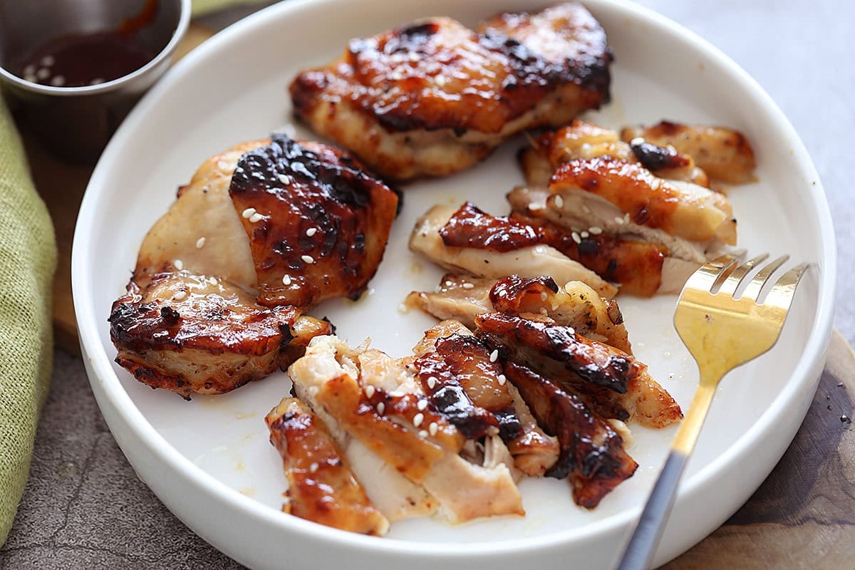 Honey chicken thighs made in the air fryer, served with chili sauce.