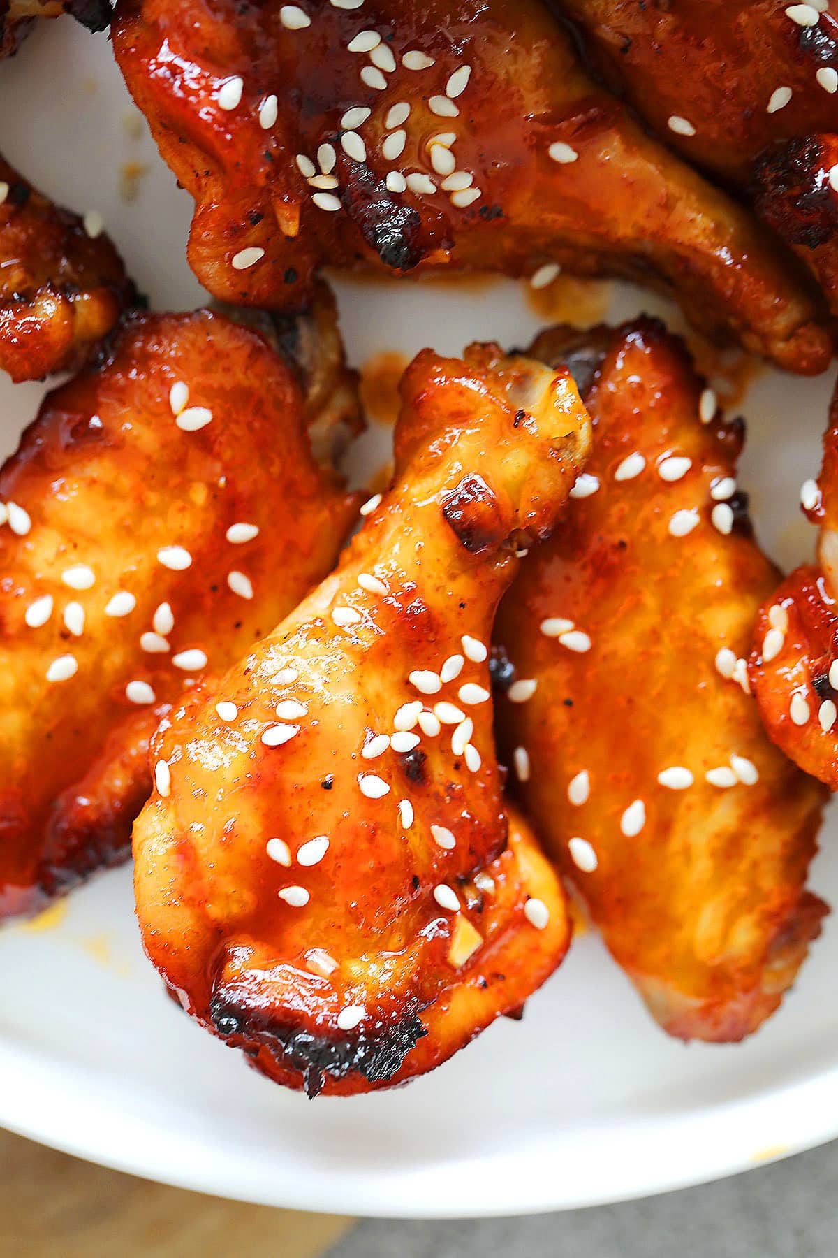Spicy air fryer Korean chicken wings topped with white sesame seeds.