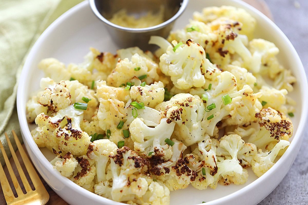 Air fryer Parmesan roasted cauliflower with crispy golden edges and a savory Parmesan cheese coating.