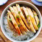 Juicy chicken in a tangy Mandarin sauce, garnished with scallions and served with rice.