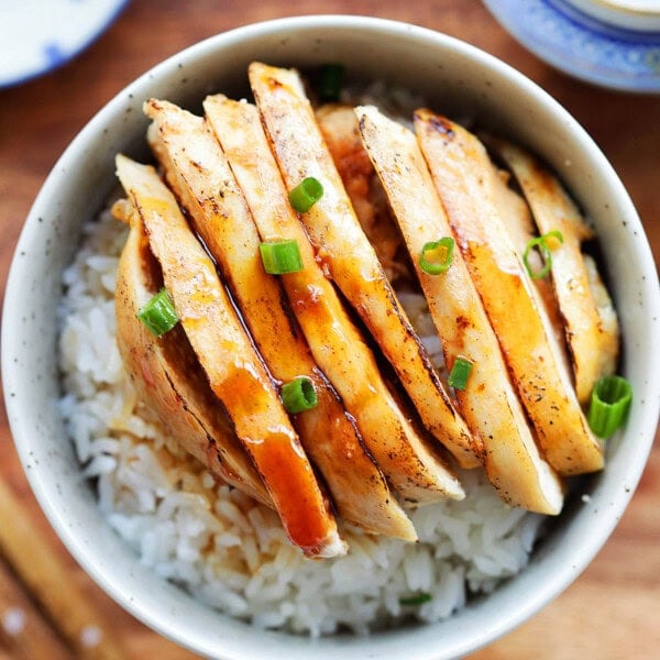 Juicy chicken in a tangy Mandarin sauce, garnished with scallions and served with rice.