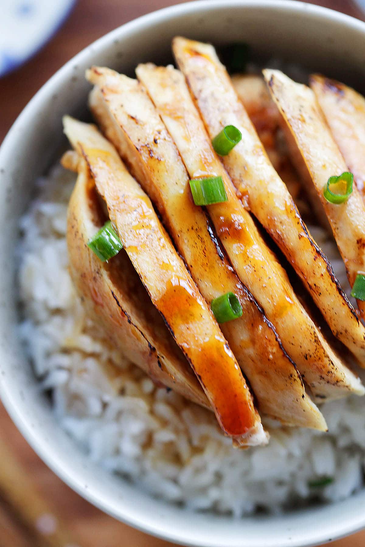 Chinese Mandarin chicken served over a bowl of rice.