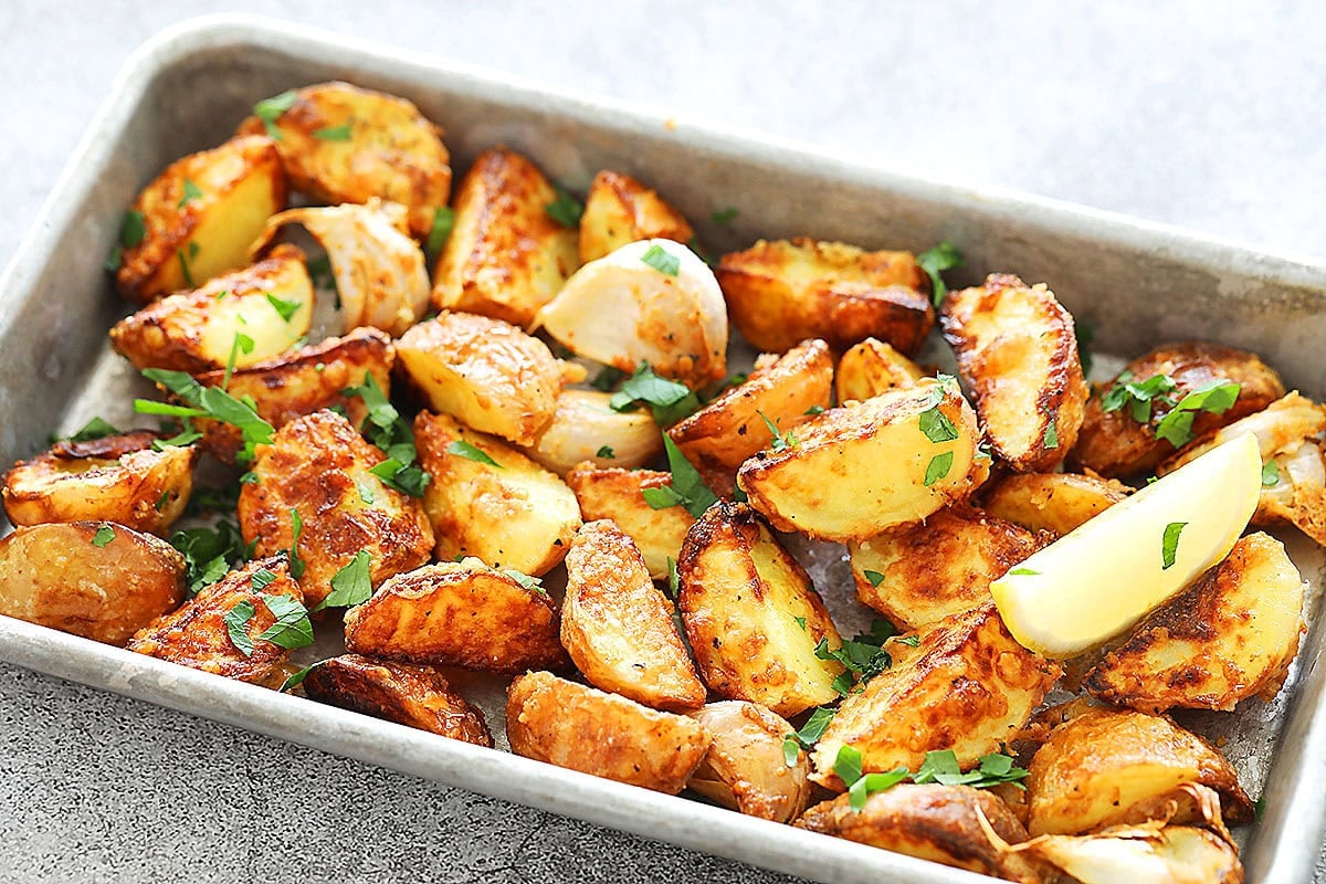 Crispy Parmesan crusted baby potatoes made in the air fryer served on a metal tray.