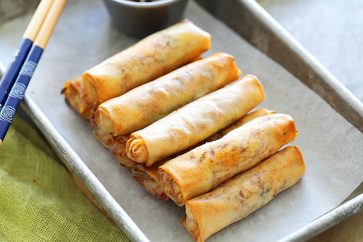 Crispy air-fried spring rolls with dipping sauce.