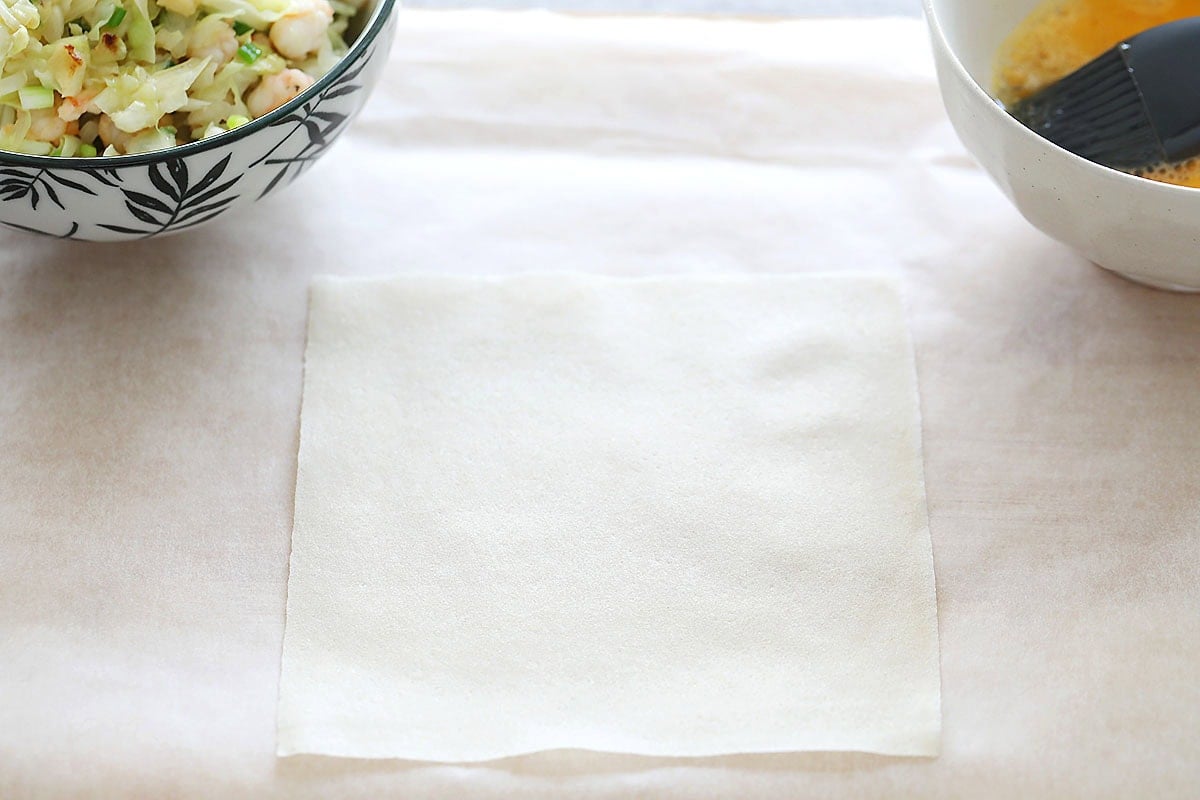 Single spring roll wrapper on parchment paper.
