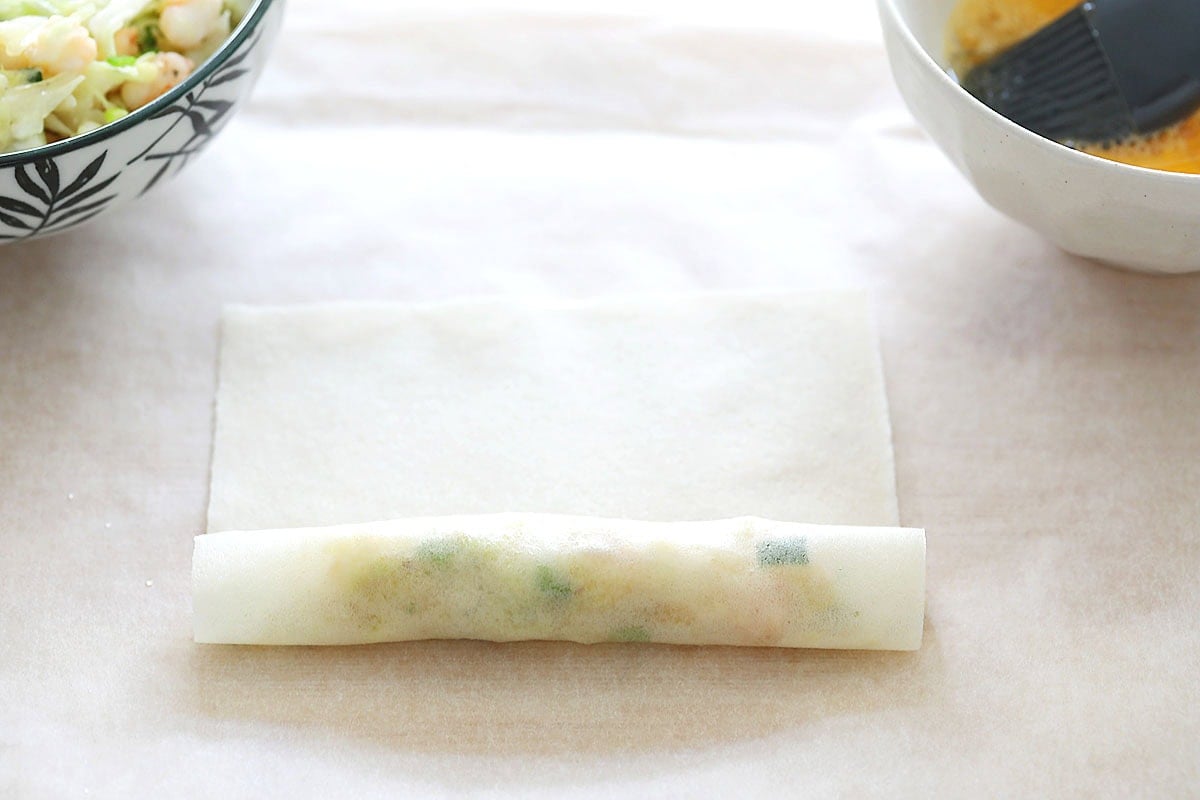 Spring roll halfway wrapped around filling.