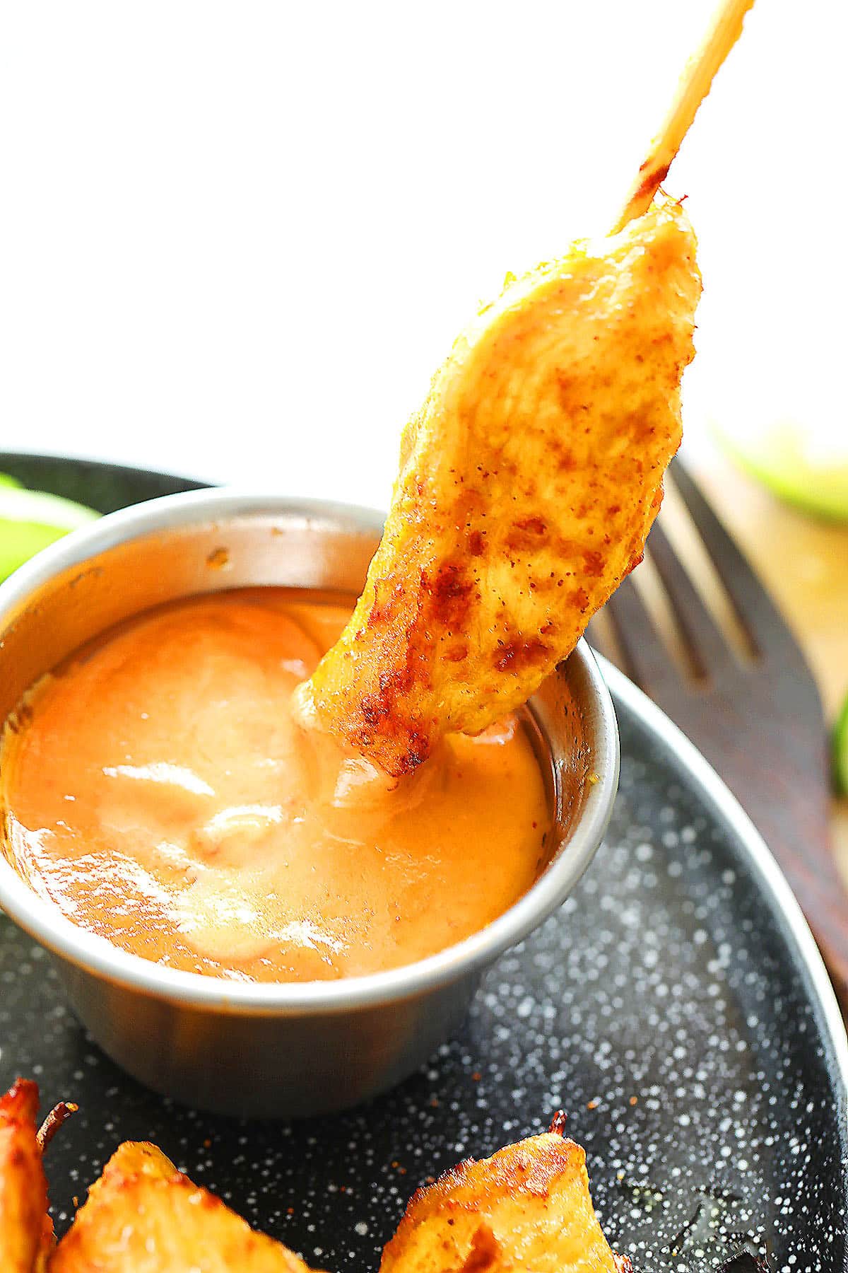 Tender Thai chicken satay skewers dipped into rich, homemade peanut sauce.