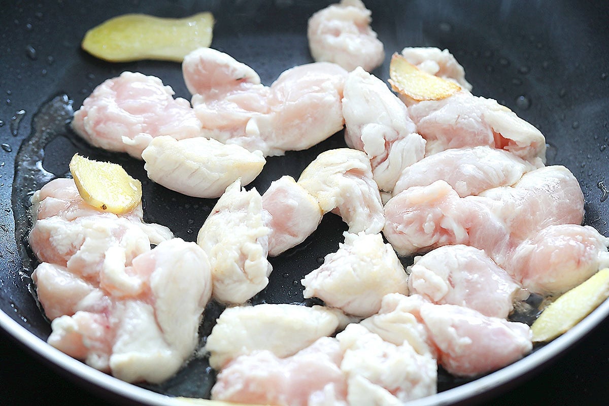 Chicken and ginger in a skillet.